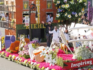 Chris Salgardo, President, Kiehl's SINCE 1851, center, rides on the Kiehl's SINCE 1851 float, winner of the Extraordinaire Trophy, during the 126th Rose Parade on Thursday, Jan. 31, 2014, in Pasadena, Calif. (Photo by Todd Williamson/Invision for Kiehl's SINCE 1851/AP Images)