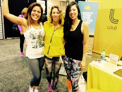 Lolë ambassador, Faten El Harake, LaLaScoop co-founder and Andiamo Body owner/trainer, Rochelle Robinson, and Lolë Community Coordinator, Jennifer Noriega, at Lolë Women Booth at 2015 IDEA World Fitness Conference in Los Angeles